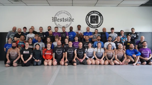 large group of people posing for picture, front row sitting, middle row kneeling, back row standing