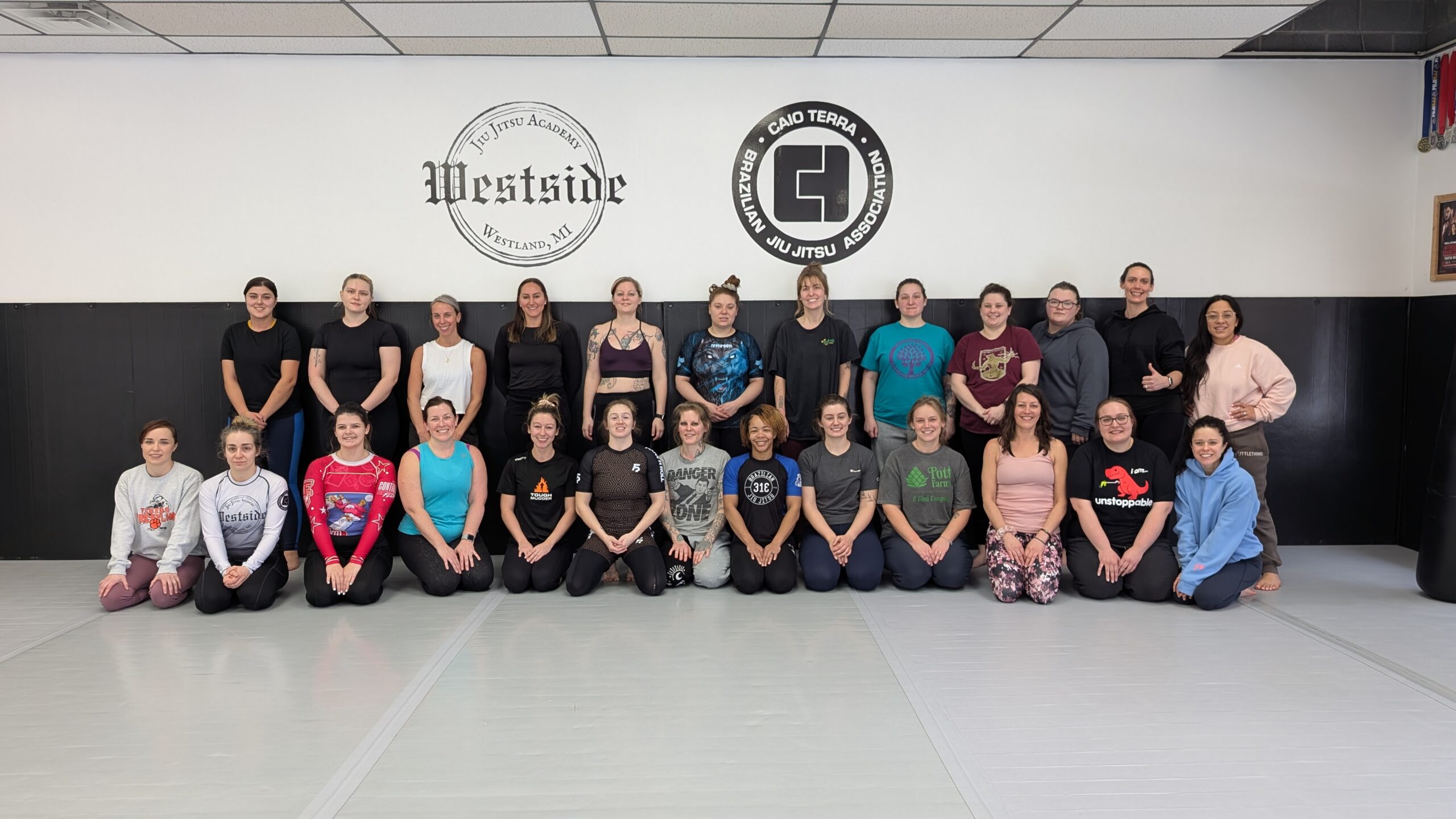 group of women posing for a photo front row kneeling and back row standing