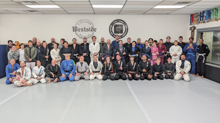 group of people wearing jiu jitsu gi's front row kneeling and back row standing